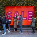 Customers queue outside a department store ahead of the Boxing Day sale in central London on December 26, 2018.