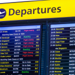 An airport departures board showing delays at Heathrow.