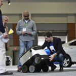 Henry Harris-Burland (R) explains the operation of the Starship Technologies delivery robot