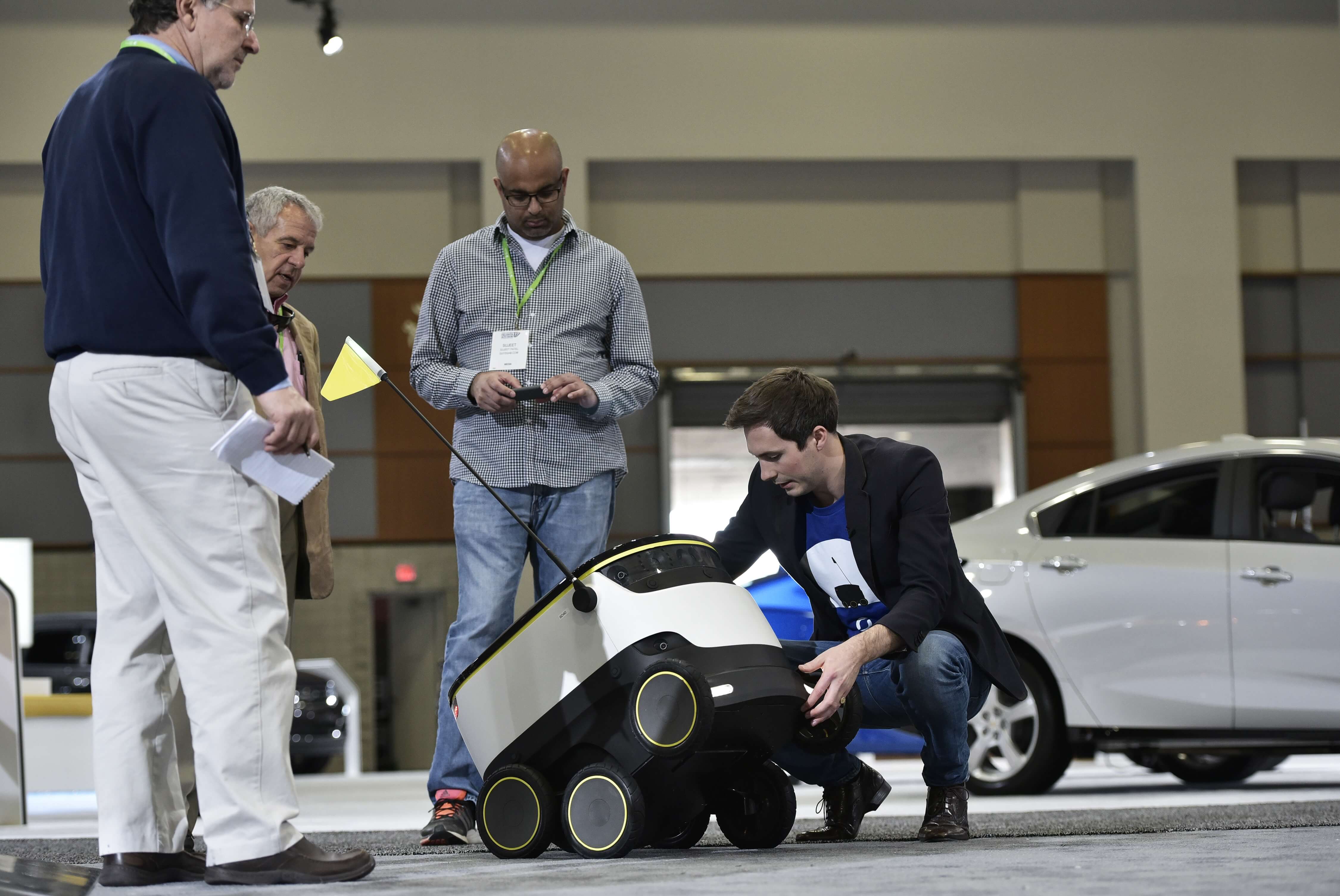 Henry Harris-Burland (R) explains the operation of the Starship Technologies delivery robot