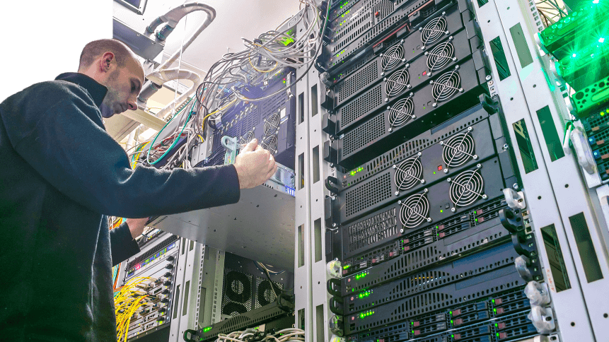 The engineer installs the new equipment in the server rack of the data center. The technical specialist works in the server room