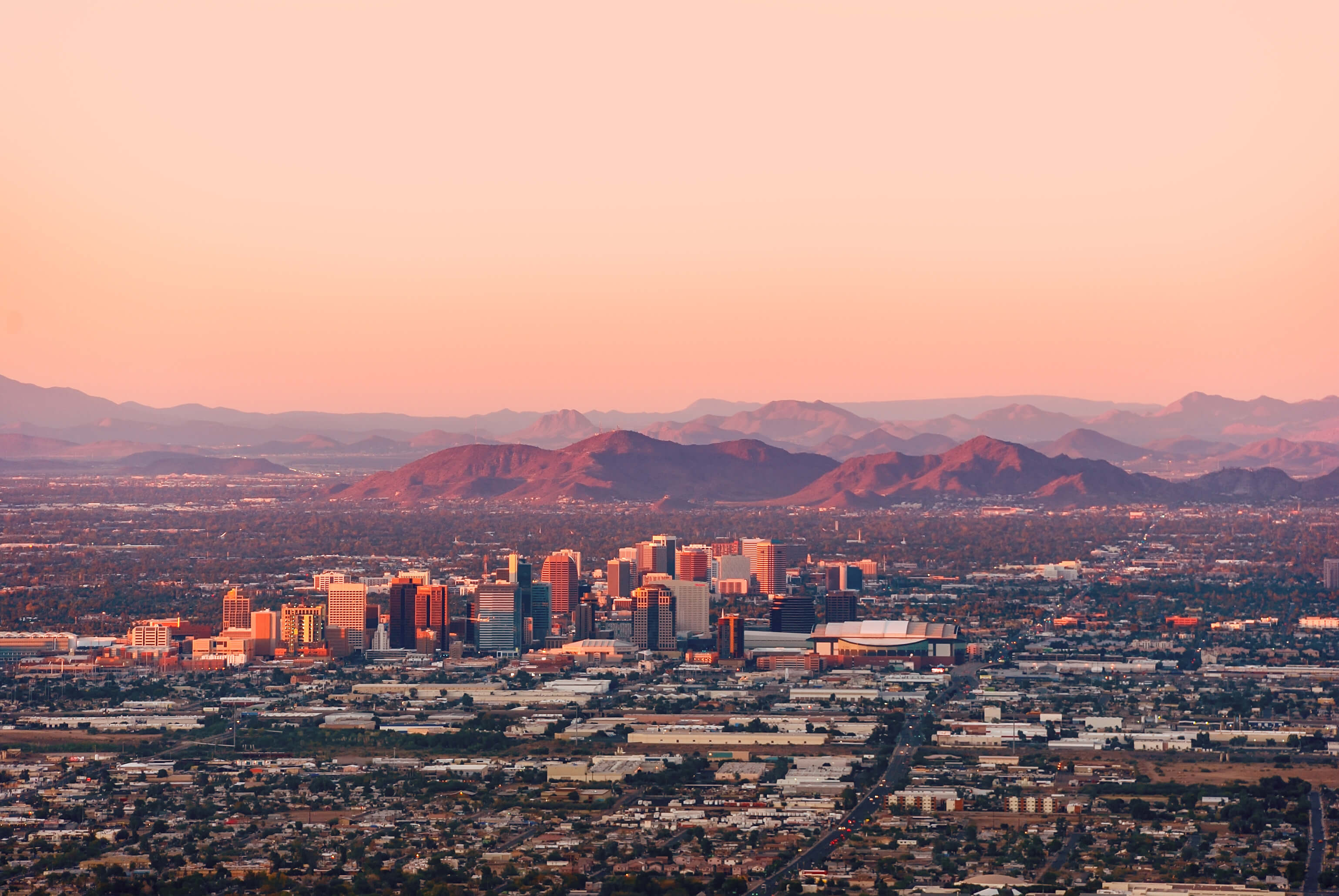 Phoenix Arizona with its downtown lit by the last rays of sun at the dusk