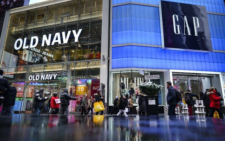 Pedestrians walk past Old Navy and GAP stores in Times Square, in New York City.