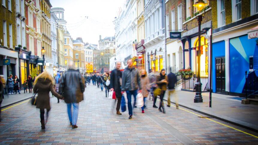 Shoppers walk down busy central London High Street