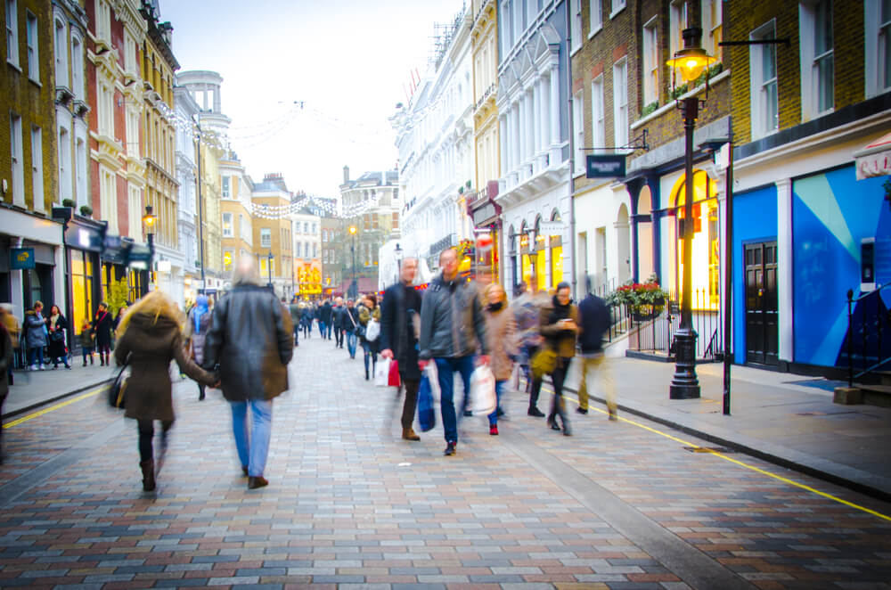 Shoppers walk down busy central London High Street