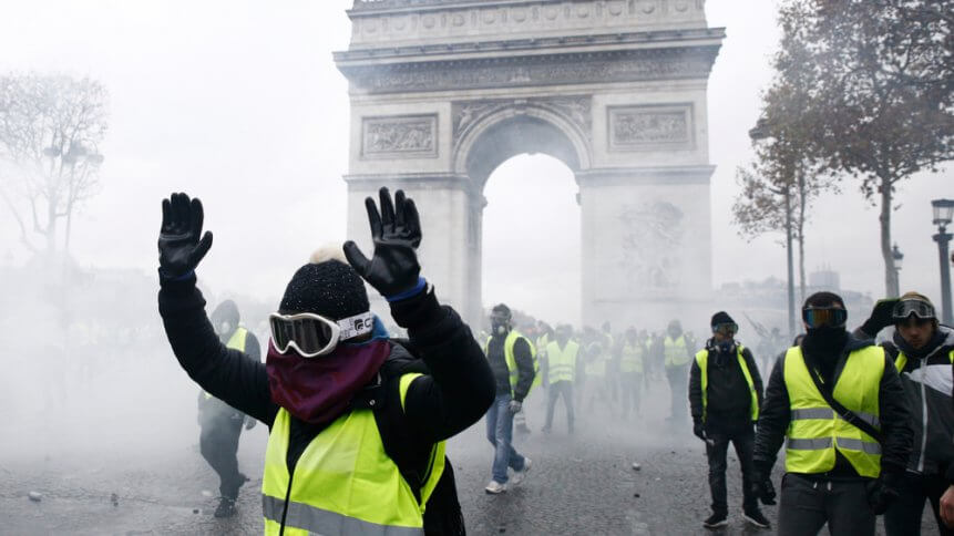 Riot Police uses a water canon and tear gas against demonstrators during a protest against the rising of the fuel and oil prices by people wearing yellow vests