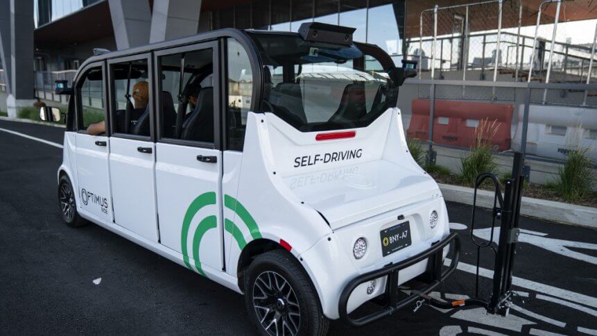 The Optimus Ride autonomous six-seater shuttle bus drives through the Brooklyn Navy Yard