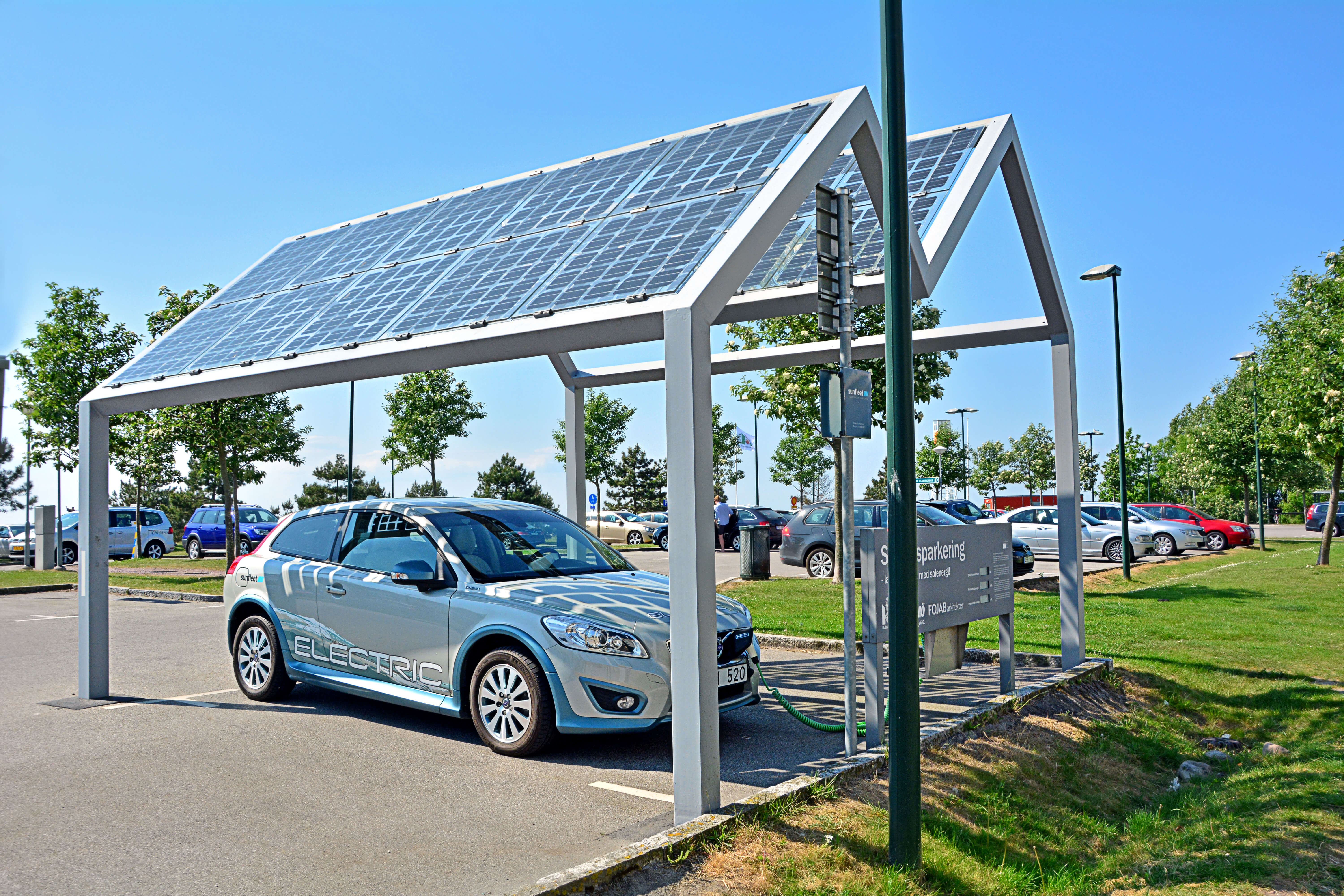 An electric car charges from a solar energy charger in Sweden.