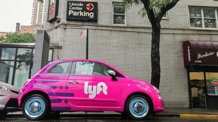 Fiat 500 painted pink and carrying a Lyft logo