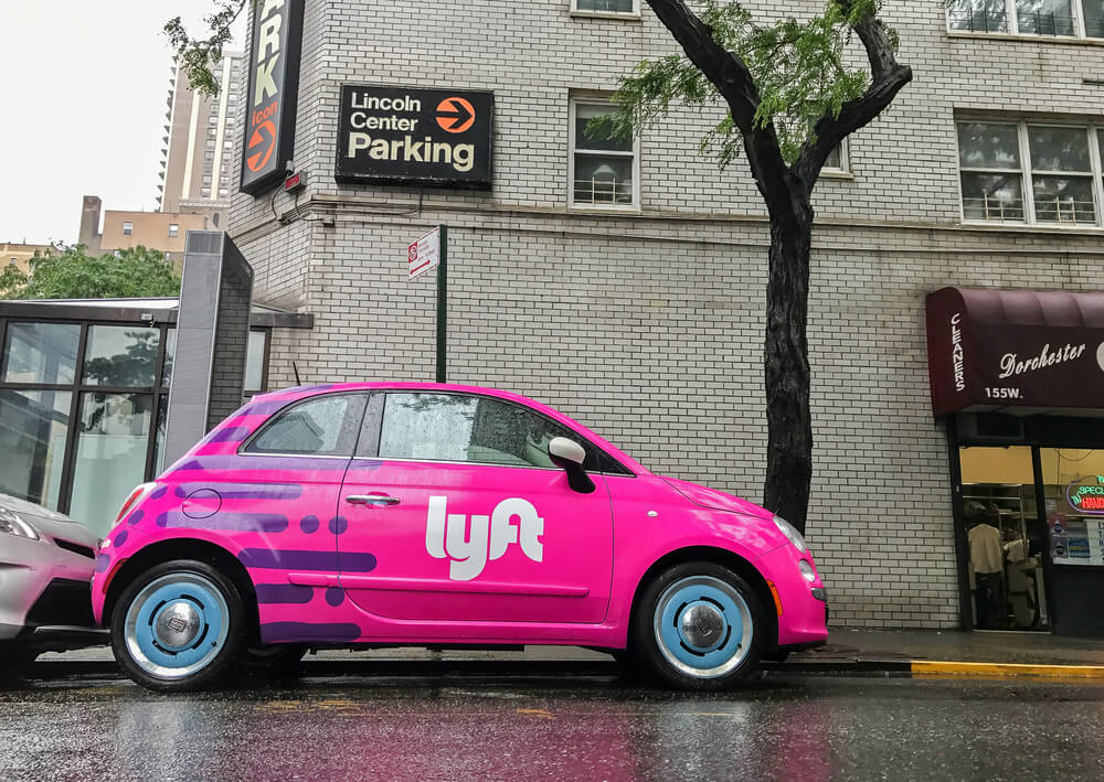 Fiat 500 painted pink and carrying a Lyft logo