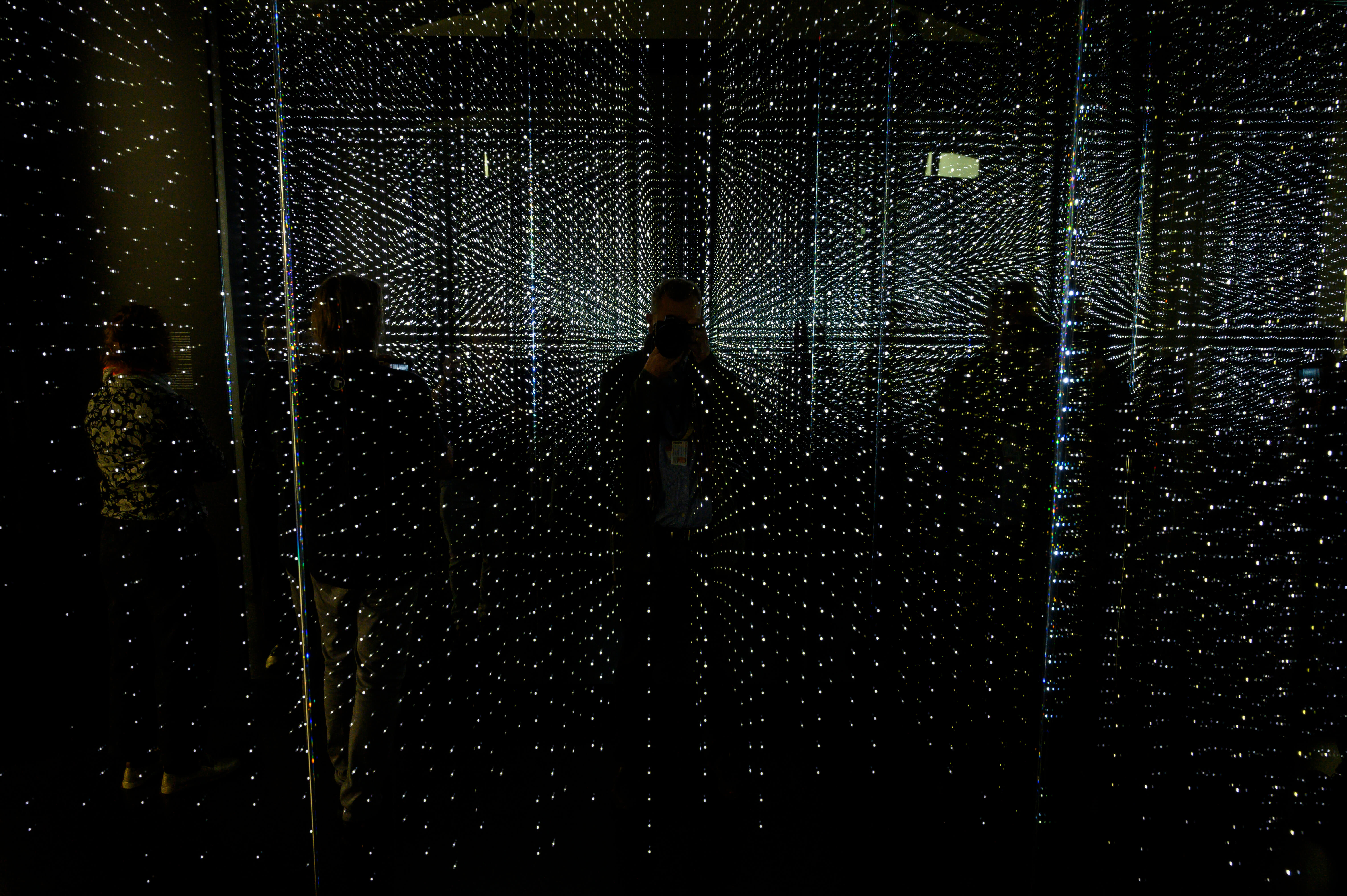 Visitors check out an infinity chamber seeking to reproduce the atmosphere of a large data centre at the "Futurium", House of Futures in Berlin