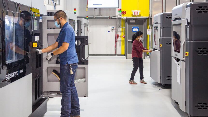 General Motors 3D printing team members working at the still-under-construction Additive Innovation Center.