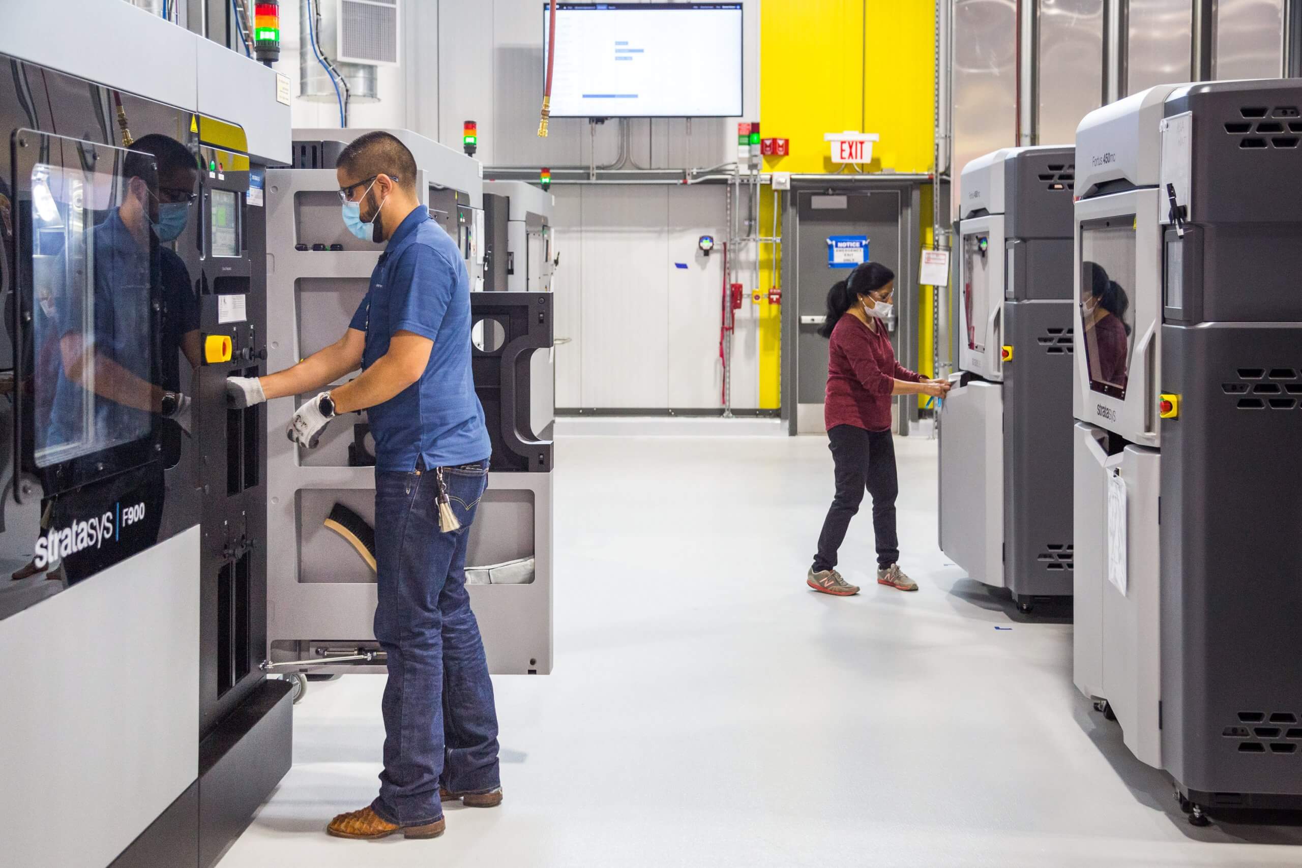 General Motors 3D printing team members working at the still-under-construction Additive Innovation Center.