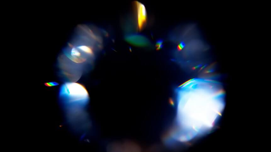 Lens Flare, Abstract Bokeh Lights. Leaking Reflection of a Glass, Diamond, Crystal. Jewelry. Defocused Shining Colorful rainbow Light Leaks, Rays on Black Background