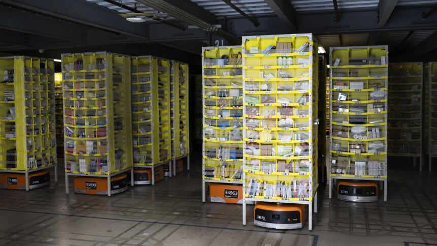 Hundreds of lawnmower-sized robots that move around shelving units in a closed field are seen during a tour of Amazon's Fulfillment Center.