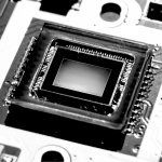 Close up shot of Smartphone CMOS camera sensor reflecting light causing colorful reflection. This semiconductor chip is used in smartphone to capture photo or image.