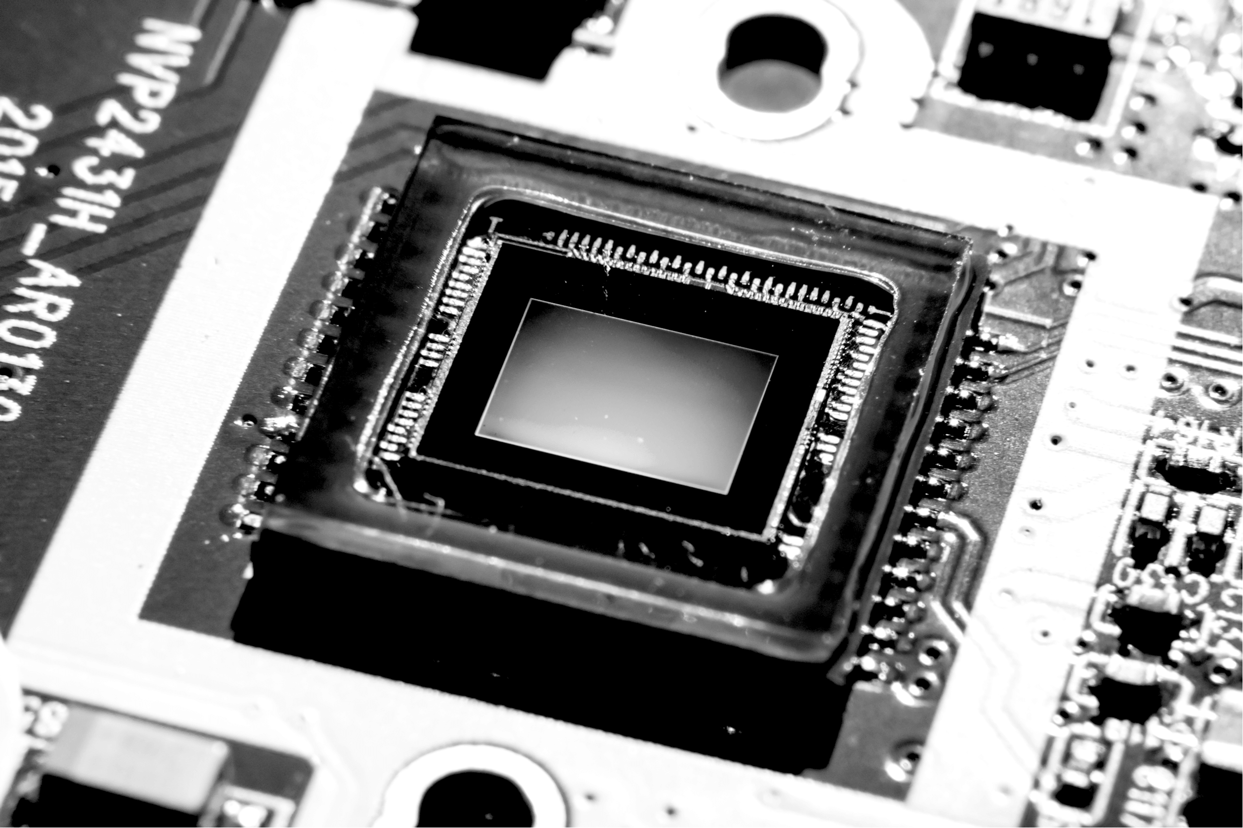 Close up shot of Smartphone CMOS camera sensor reflecting light causing colorful reflection. This semiconductor chip is used in smartphone to capture photo or image.
