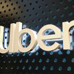 Close up of a lighted Uber logo sign at an Uber lounge at the Westfield Century City mall in Century City.