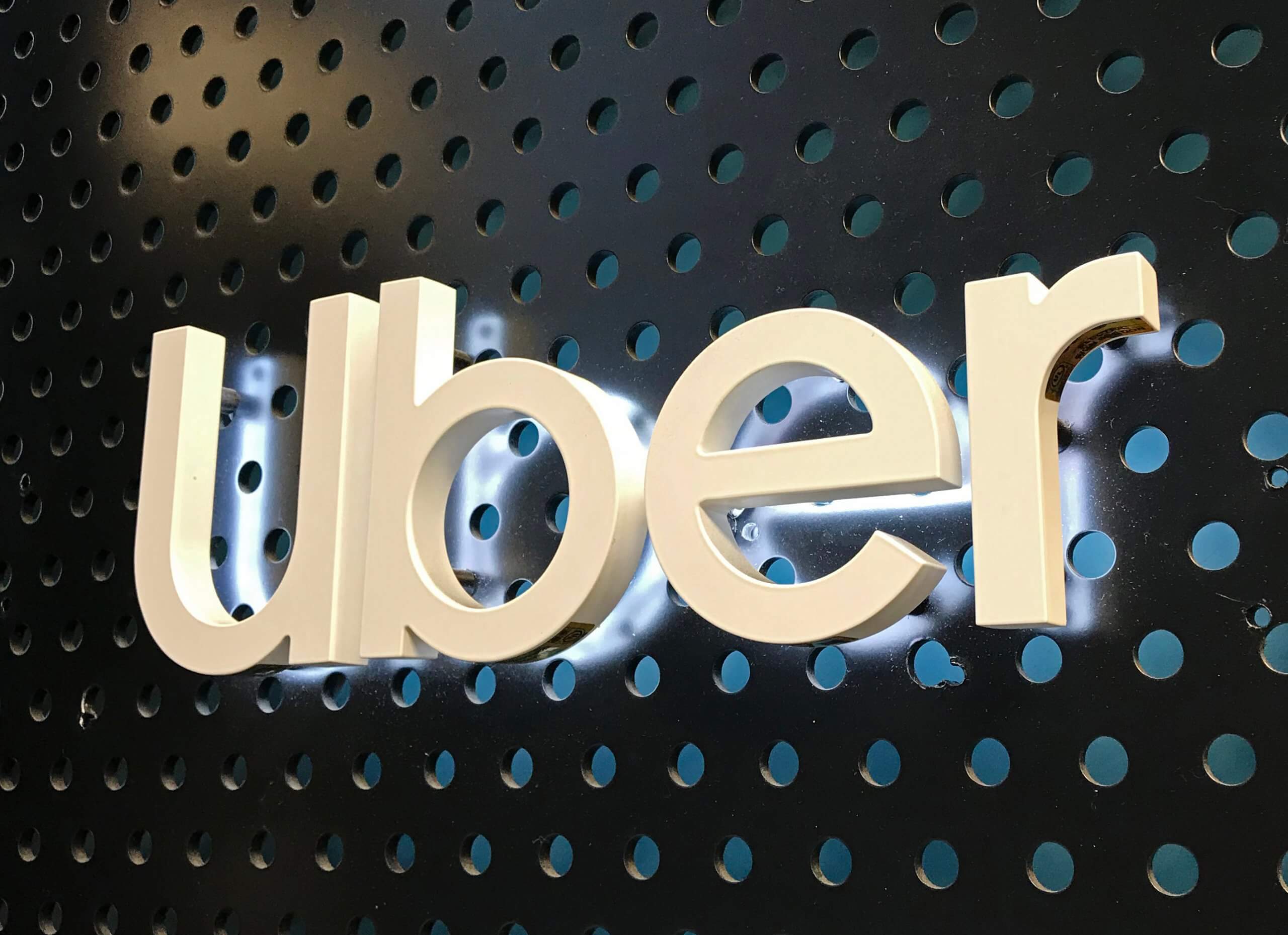 Close up of a lighted Uber logo sign at an Uber lounge at the Westfield Century City mall in Century City.