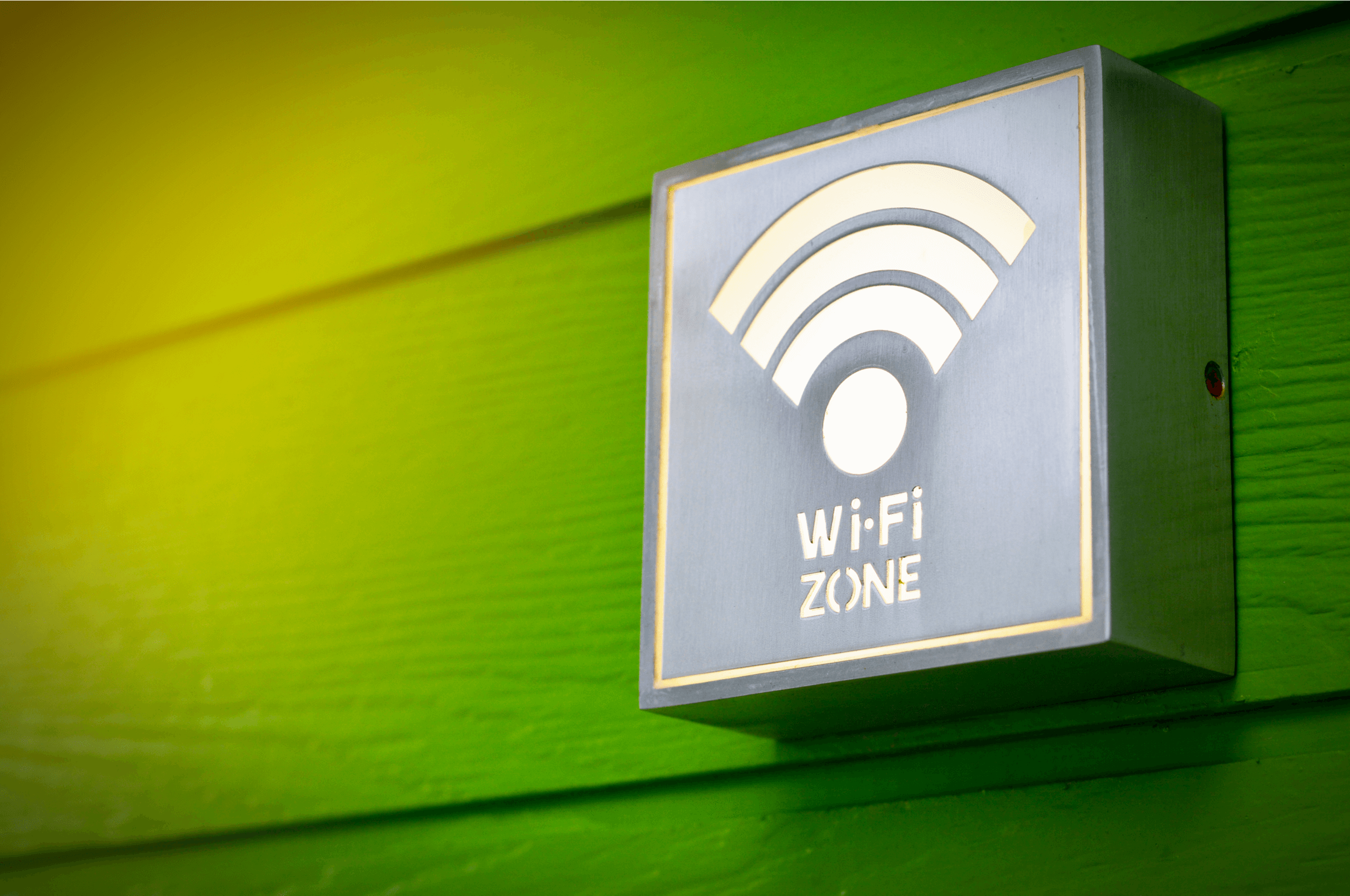 WiFi zone sign and symbol or Wifi area sign on the green wood background with softlight