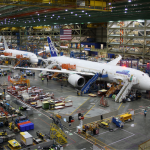 Unidentified Boeing employees continue work building a Boeing 787 jets at its Everett factory, including for Japanese airline All Nippon Airways