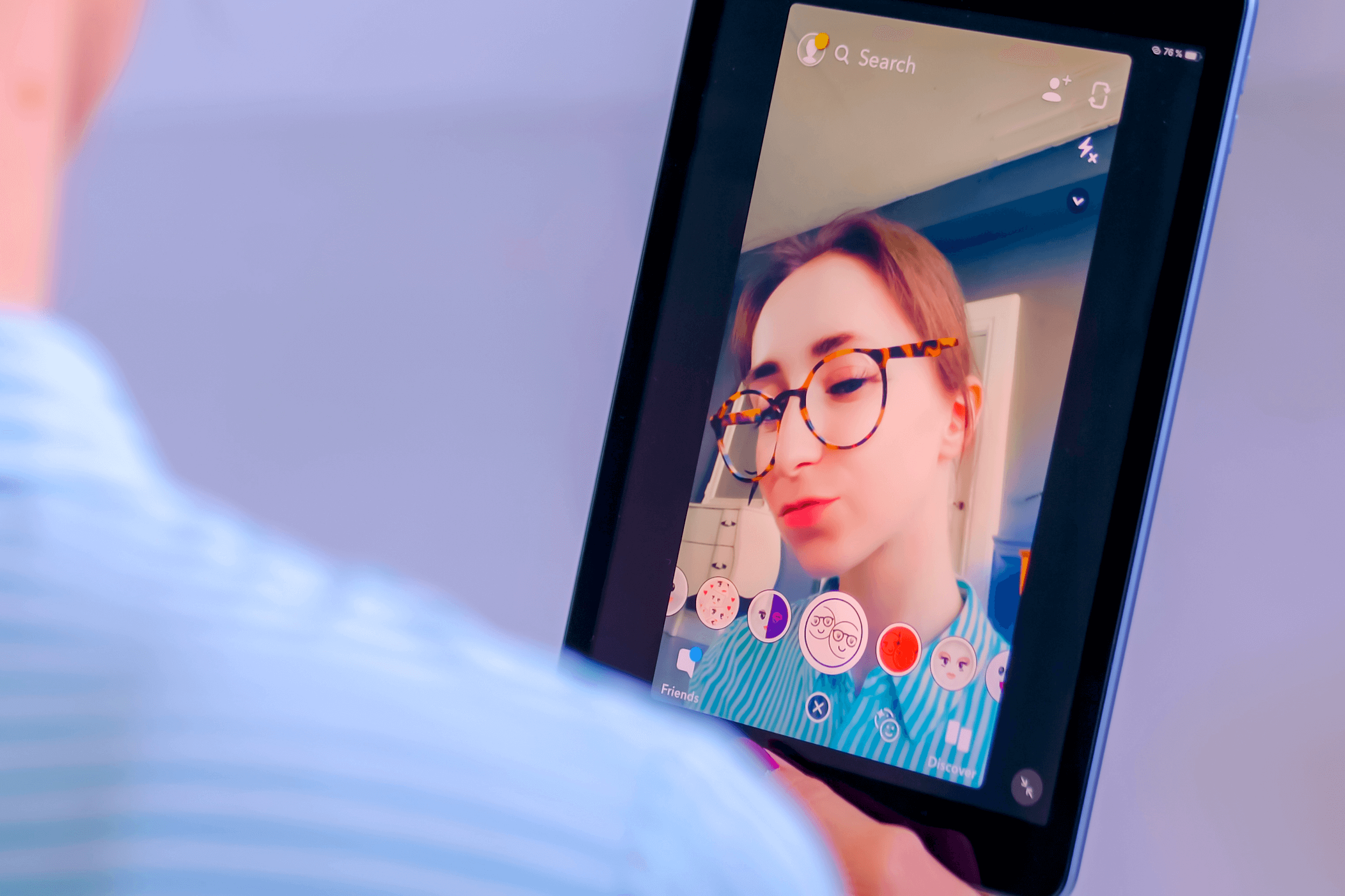 Snapchat multimedia messager with 3d face mask filter on tablet in woman hands at home. Face detection technology, AR, social media, selfie, entertainment concept