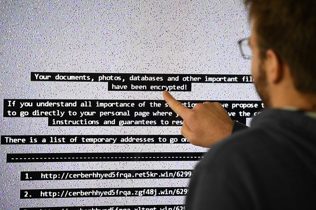 An IT researcher shows on a giant screen a computer infected by a ransomware