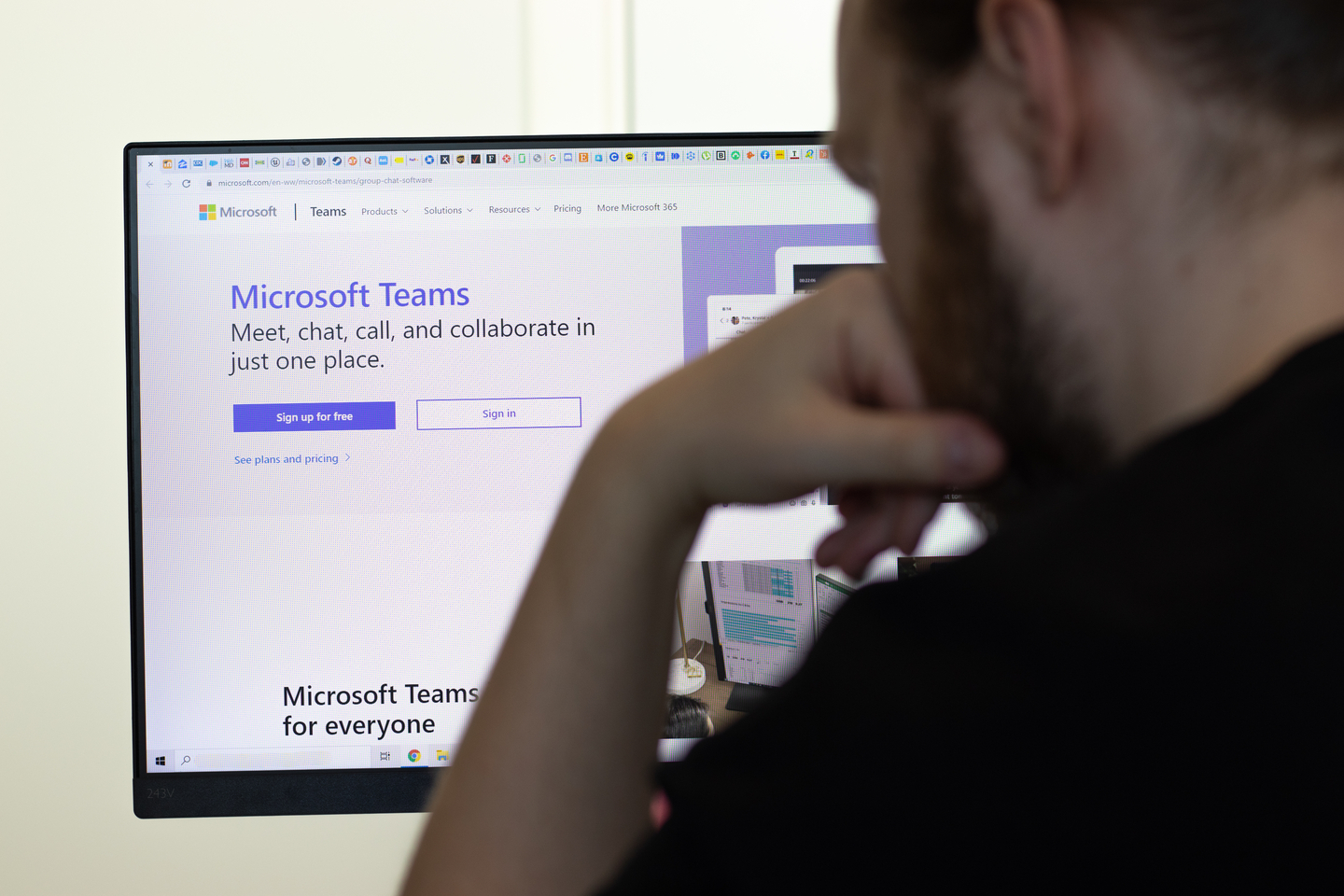 A man stares at Microsoft Teams on his computer.