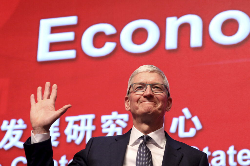 Apple CEO Tim Cook waves as he arrives for the Economic Summit held for the China Development Forum in Beijing on March 23, 2019. (Photo by Ng Han Guan / POOL / AFP)