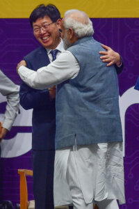 Foxconn Chairman and CEO Young Liu (L) greets Indian Prime Minister Narendra Modi, during SemiconIndia 2023, at Mahatma Mandir in Gandhinagar on July 28, 2023. (Photo by SAM PANTHAKY / AFP)