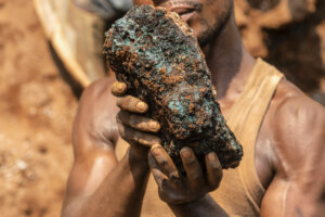 Dela wa Monga, an artisanal miner, holds a cobalt stone at the Shabara artisanal mine near Kolwezi, Democratic Republic of the Congo The metal is used in the rechargeable batteries that power mobile phones and electric cars. Source: AFP