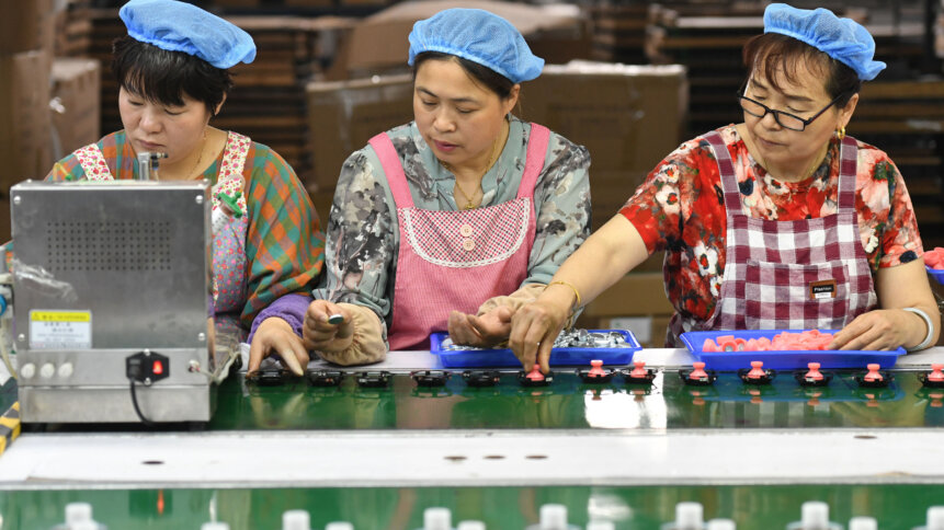 Employees work on an assembly line producing speakers at a factory in Fuyang, China. Is forced labor rearing its ugly head?