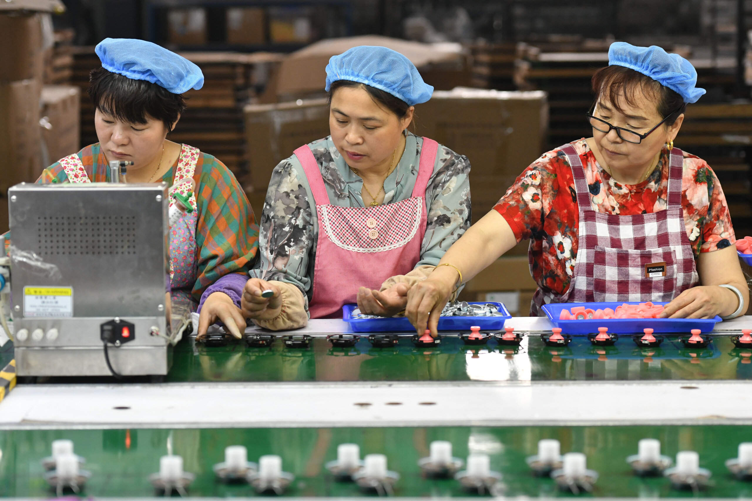 Employees work on an assembly line producing speakers at a factory in Fuyang, China. Is forced labor rearing its ugly head?