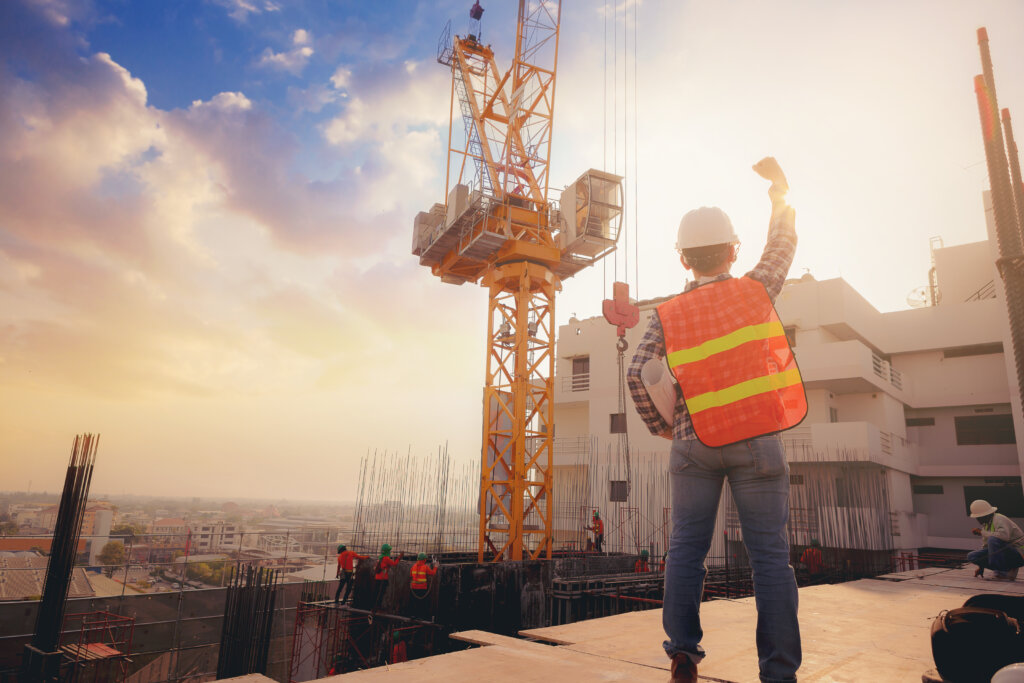 A not-for-free stock photo of someone punching the air on a construction site.