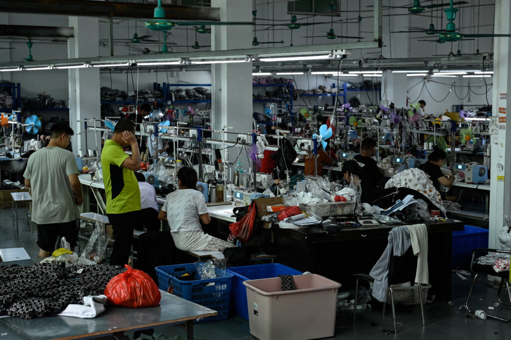 Workers make clothes at a garment factory that supplies Shein. (Photo by Jade Gao / AFP)