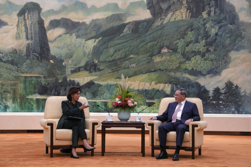 China's Premier Li Qiang (R) speaks with US Commerce Secretary Gina Raimondo during their meeting at the Great Hall of the People in Beijing on August 29, 2023. (Photo by Andy Wong/POOL/AFP).