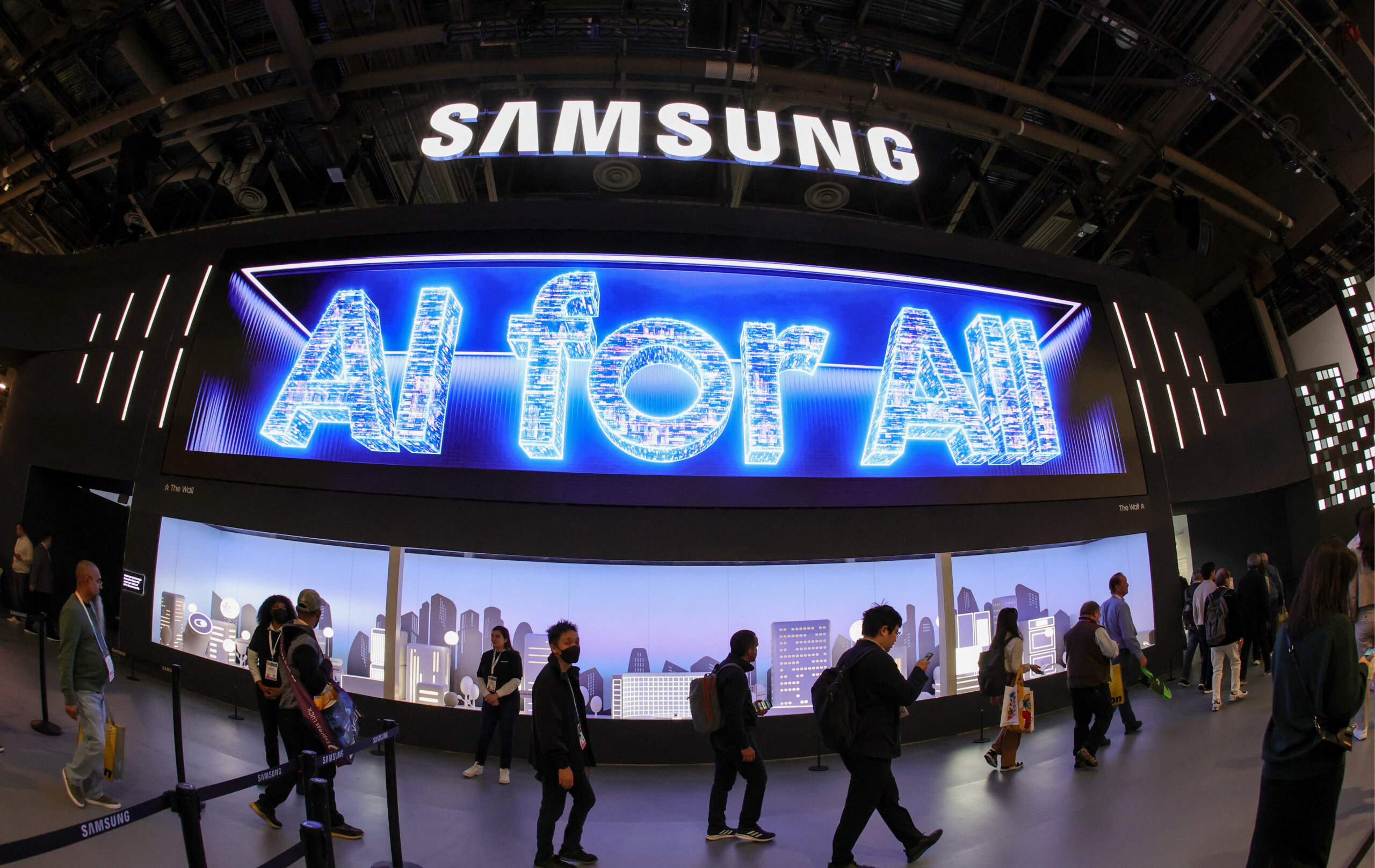 Attendees enter the Samsung booth as a digital message "AI for All" is displayed during CES 2024 at the Las Vegas Convention Center. (Photo by Ethan Miller/GETTY IMAGES NORTH AMERICA/Getty Images via AFP).